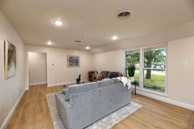 Living area featuring light wood-type flooring, baseboards, and recessed lighting | Image 5