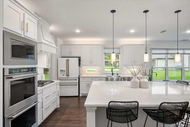 Kitchen has SS appliances, double ovens, and built-in microwave. | Image 13