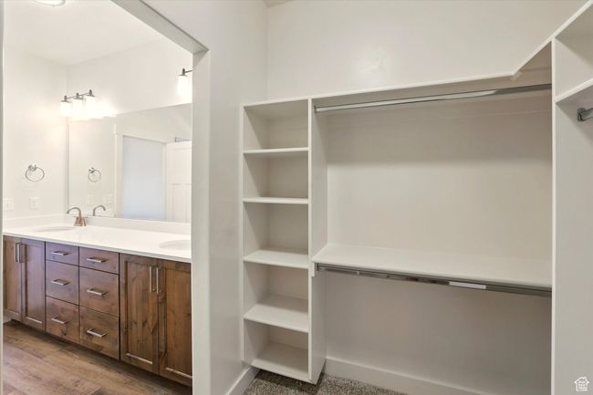 Full bath with double vanity and wood finished floors | Image 21