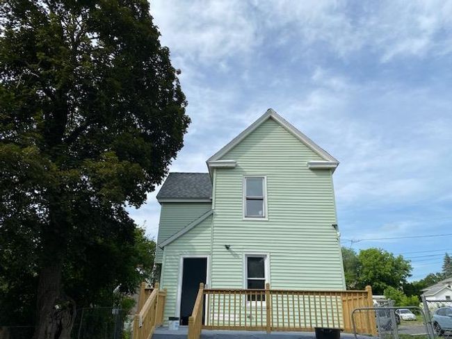 Rear view of house featuring a deck and a shingled roof | Image 4