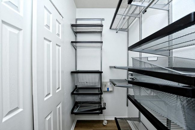 Walk in closet featuring wood finished floors | Image 12