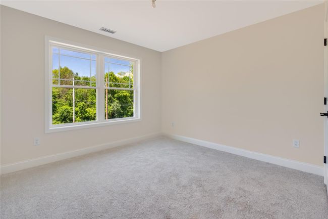 Carpeted spare room with baseboards, visible vents, and a ceiling fan | Image 29