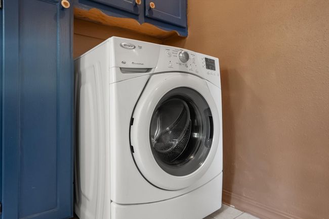 Laundry area with washer / clothes dryer, cabinet space, and light tile patterned floors | Image 21