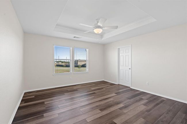 Large primary bedroom upstairs. With beautiful LVP floor and tray ceilings. | Image 22