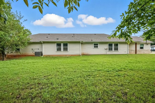 Rear view of house featuring roof with shingles and a yard | Image 17