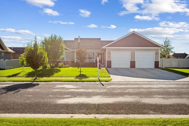 Ranch-style house with a garage, concrete driveway, and brick siding | Image 6