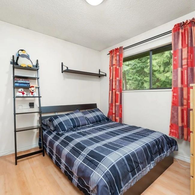 Bedroom featuring wood finished floors, baseboards, and a textured ceiling | Image 7