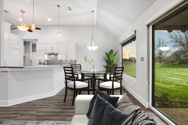 Dining space featuring dark hardwood / wood-style floors, lofted ceiling, and sink | Image 5