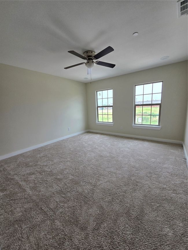 Carpeted spare room with baseboards and ceiling fan | Image 20