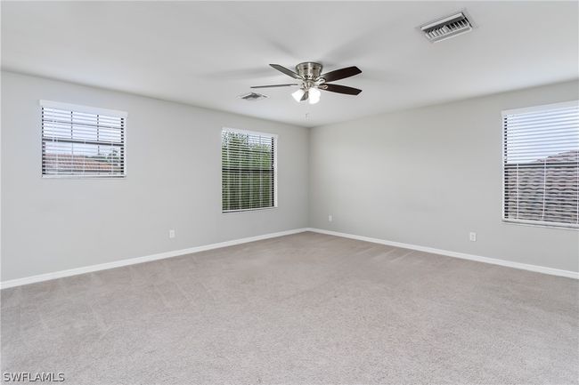 Carpeted spare room featuring ceiling fan | Image 16