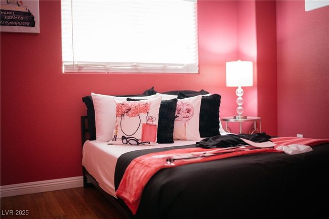 Bedroom with multiple windows, wood finished floors, and baseboards | Image 10