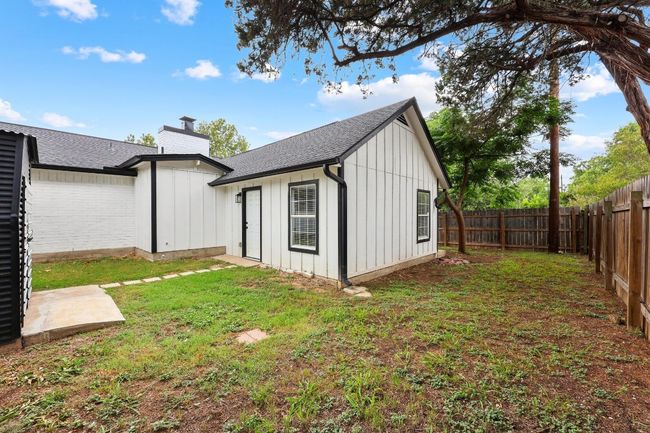 View of back of home with a fenced backyard | Image 28