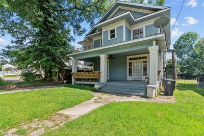 View of front facade featuring a front lawn and a porch | Image 1