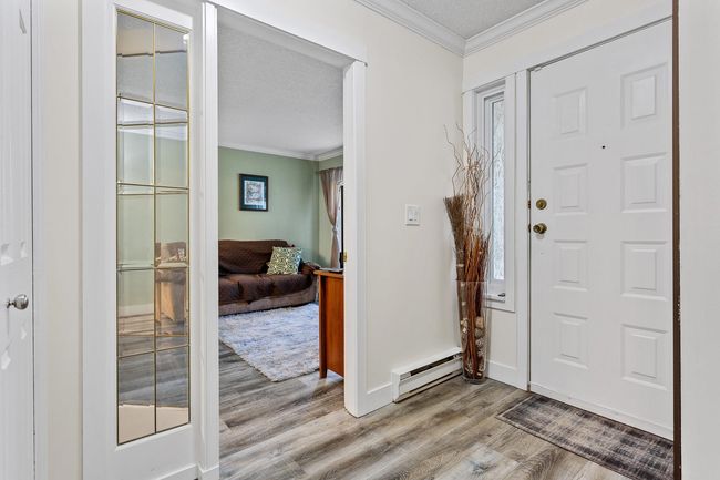 Foyer featuring wood finished floors, crown molding | Image 4