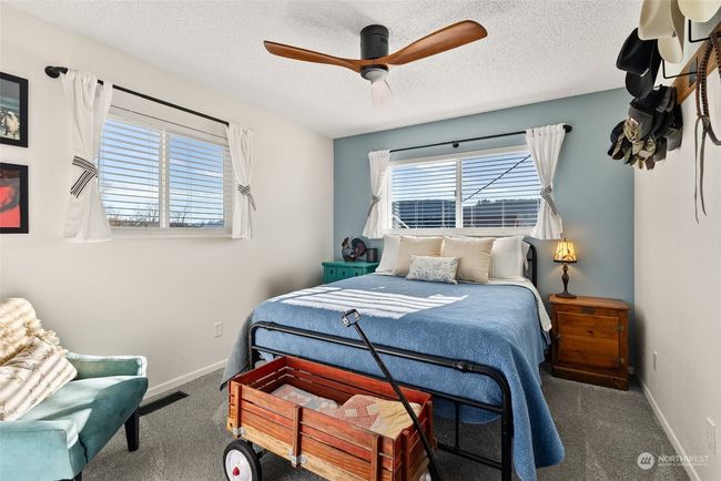 One of the three bedrooms on the upper level, each offers comfortable living space and convenient access to the nearby hall bath. This thoughtful layout ensures both functionality and ease for family and guests alike | Image 16