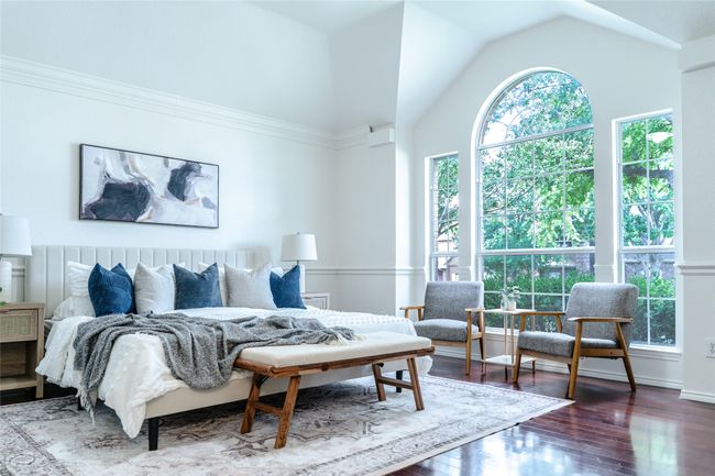 Bedroom with wood finished floors and lofted ceiling | Image 26