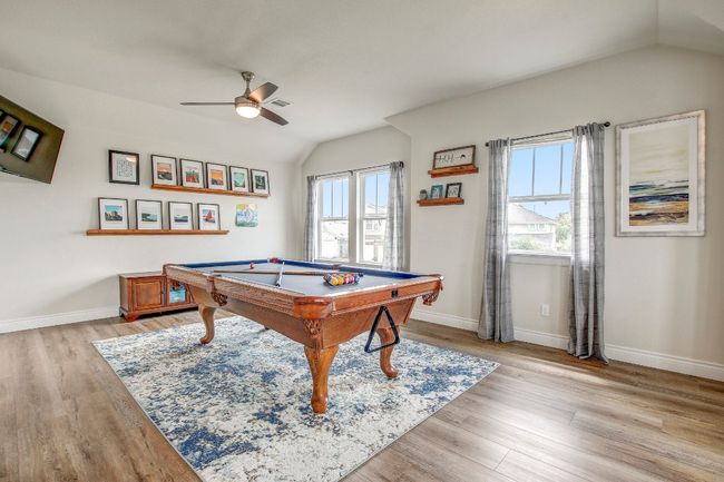 Rec room with vaulted ceiling, billiards table, a ceiling fan, plenty of natural light, and light wood-style floors | Image 26