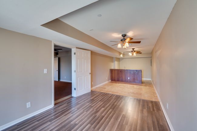 Third room in the basement features a kitchen/bar area with large space for more entertaining. | Image 36