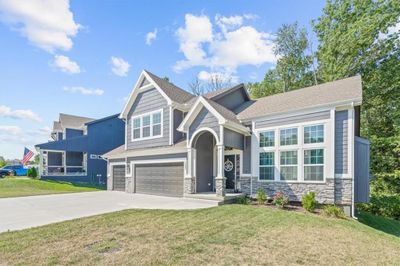 Craftsman inspired home with a garage and a front yard | Image 2