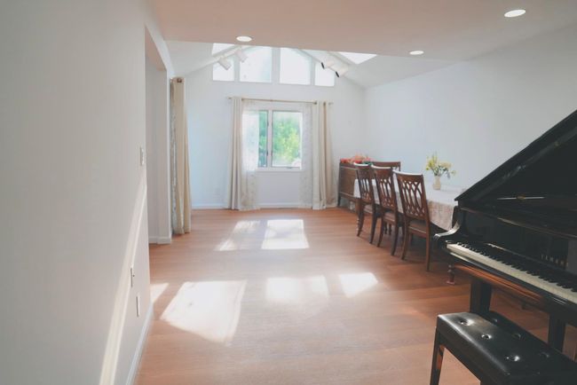 Dining room with wood finished floors, a skylight, vaulted ceiling, and recessed lighting | Image 4
