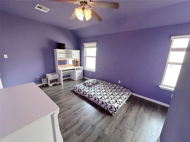 Bedroom with wood finished floors and a ceiling fan | Image 26