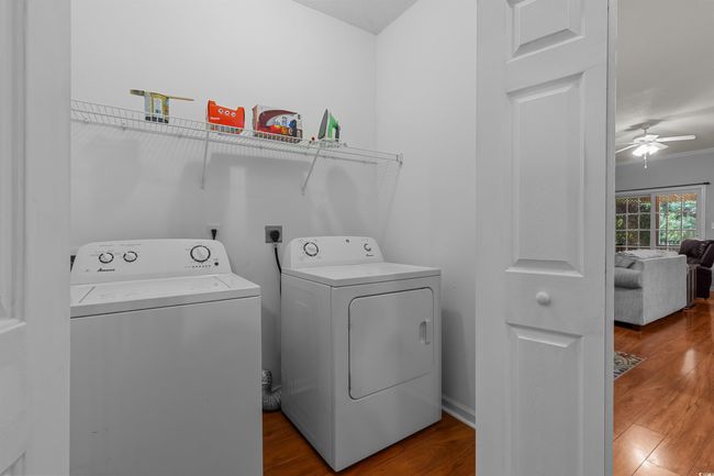 Washroom with separate washer and dryer, ceiling fan, and wood finished floors | Image 4