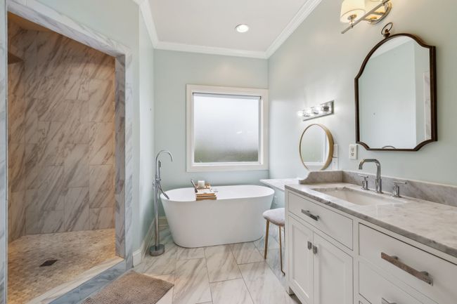 The soaking tub and large walk in shower compliment the dual vanity with trendy brass accents. | Image 30