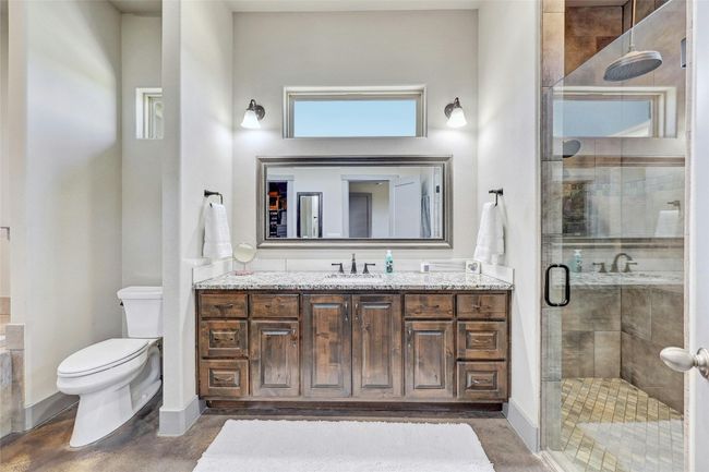 A large walk-in shower along with plenty of cabinets and more natural light from elevated privacy windows. | Image 18