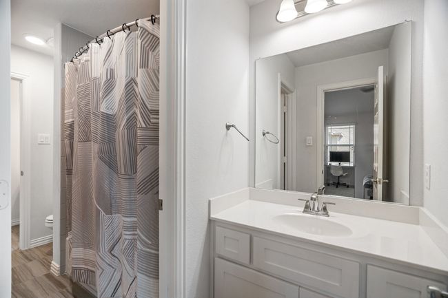 Bathroom featuring vanity and curtained shower | Image 31