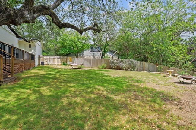 Fenced backyard with an outdoor fire pit | Image 36