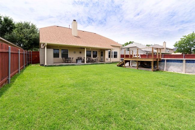 Large grass area next to the above ground pool | Image 30