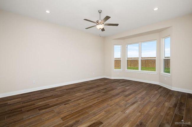 Spare room featuring dark wood-type flooring, ceiling fan, baseboards, and recessed lighting | Image 18