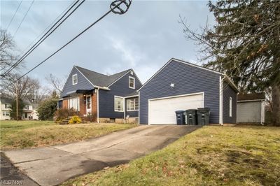 Front facade with a garage and a front yard | Image 2