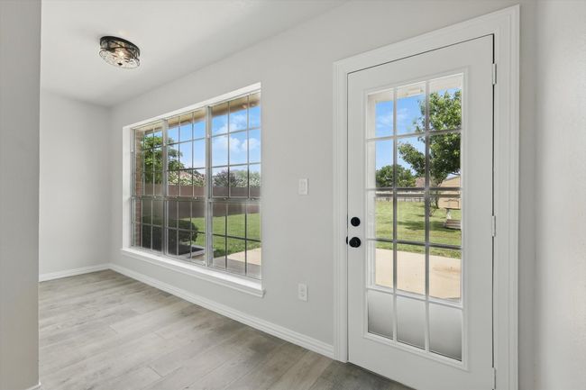 Doorway featuring baseboards and wood finished floors | Image 16