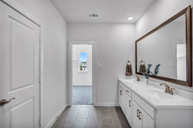 Bright and spacious primary bath suite with dual sink vanity, shower, and private water closet. | Image 19