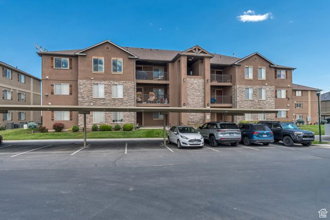 View of apartment complex with covered parking | Image 20