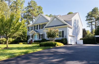 Front of house with wide driveway and 2-car garage | Image 2