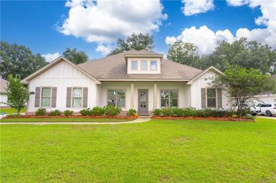 View of front facade with a front lawn | Image 1