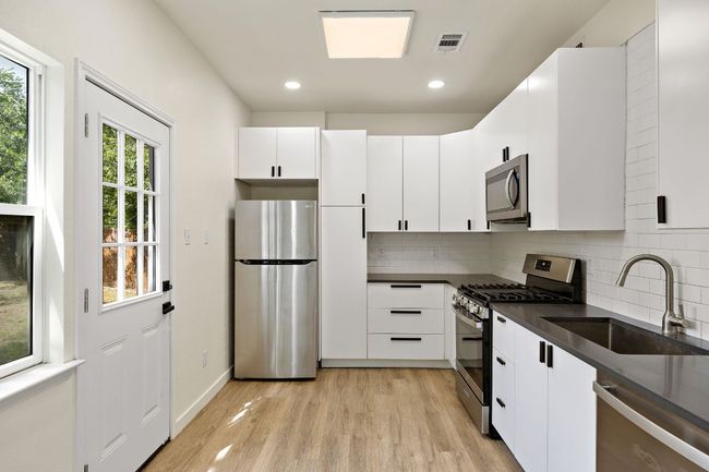 Updated modern kitchen with new cabinets, stainless steel appliances, quart countertops | Image 9