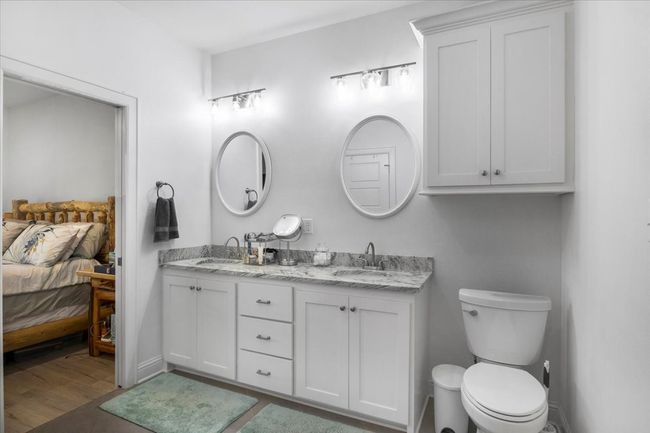 Ensuite bathroom with a sink, double vanity, ensuite bathroom, toilet, and wood finished floors | Image 20