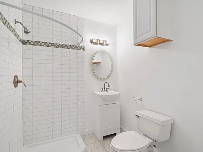 Bathroom featuring a shower stall and vanity | Image 18