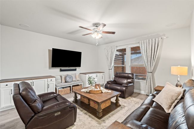 Living room featuring light wood-style floors and ceiling fan | Image 8
