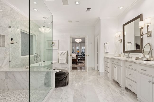 Incredible Primary Bath with stone floors and large glass enclosed shower | Image 18