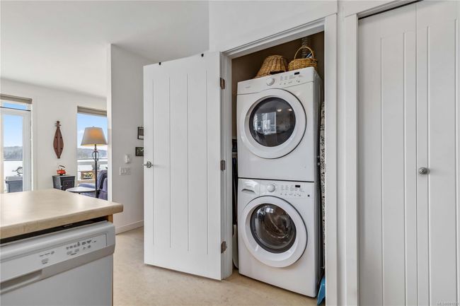 Laundry room with laundry area and stacked washer / dryer | Image 15