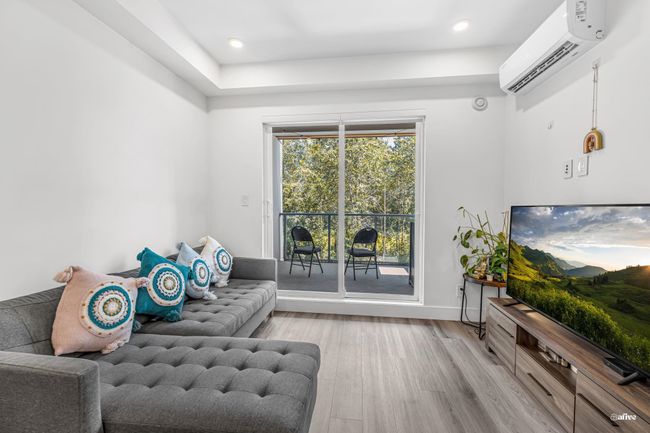 Sitting room featuring an AC wall unit, light wood-type flooring, and recessed lighting | Image 9