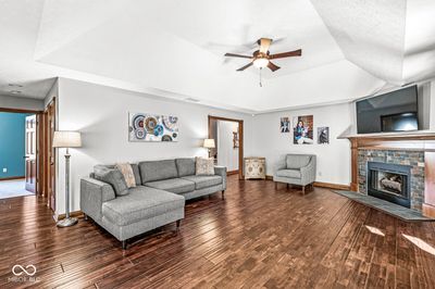 The family room is approximately 22 x15 - beautiful wood flooring, access to sunroom, fireplace | Image 2