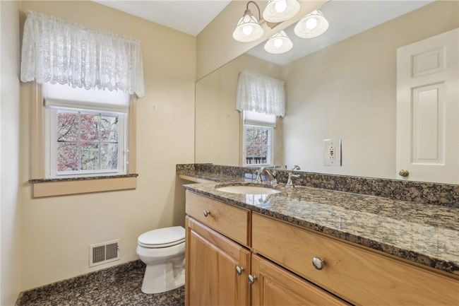 Updated Half Bath on main floor with granite counters and floor. | Image 12
