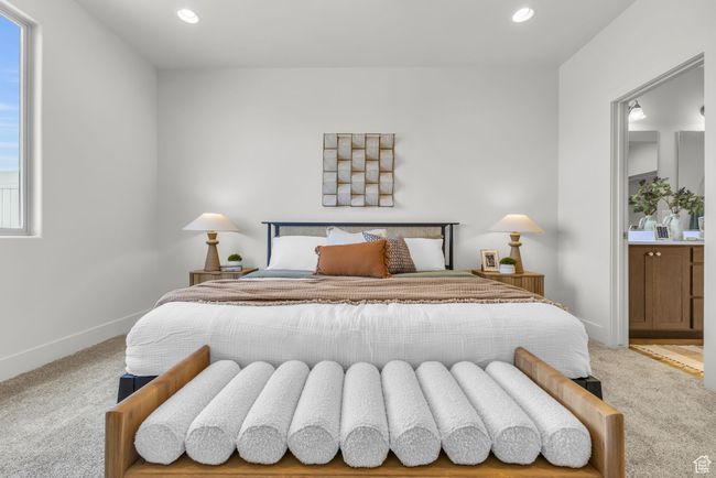 Bedroom featuring carpet flooring, ensuite bath, and multiple windows | Image 18