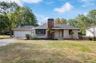 View of front of house with a garage and a front lawn | Image 1