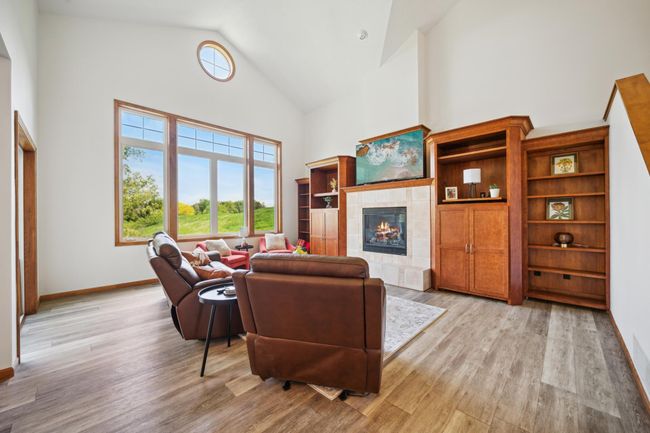 The main level features soaring vaulted ceilings and an abundance of windows that flood the space with natural light. | Image 10